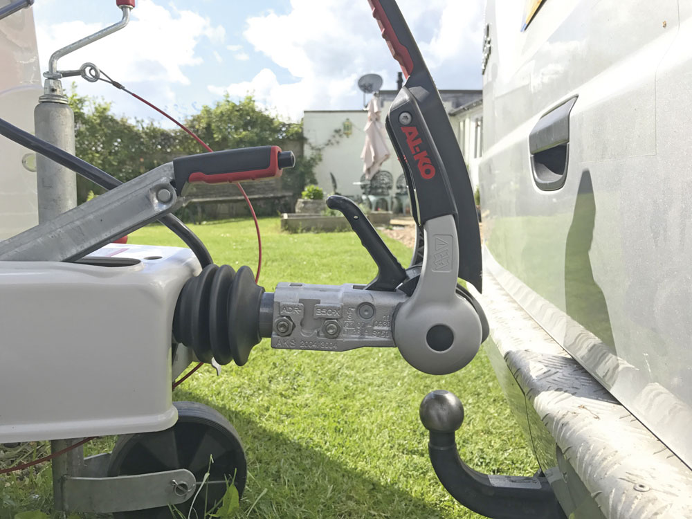 A tow bar and hitch ball for a caravan