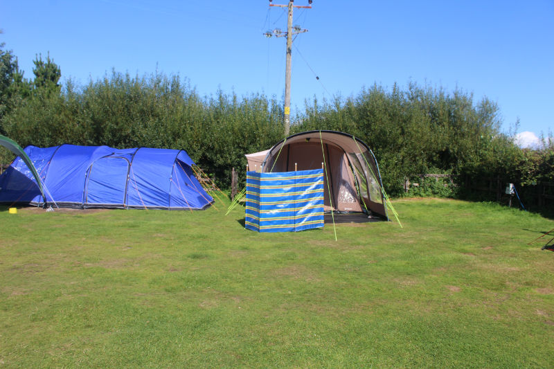A Tent pitched with a windbreak