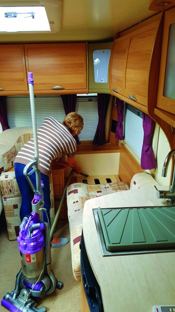 Kim cleaning inside caravan