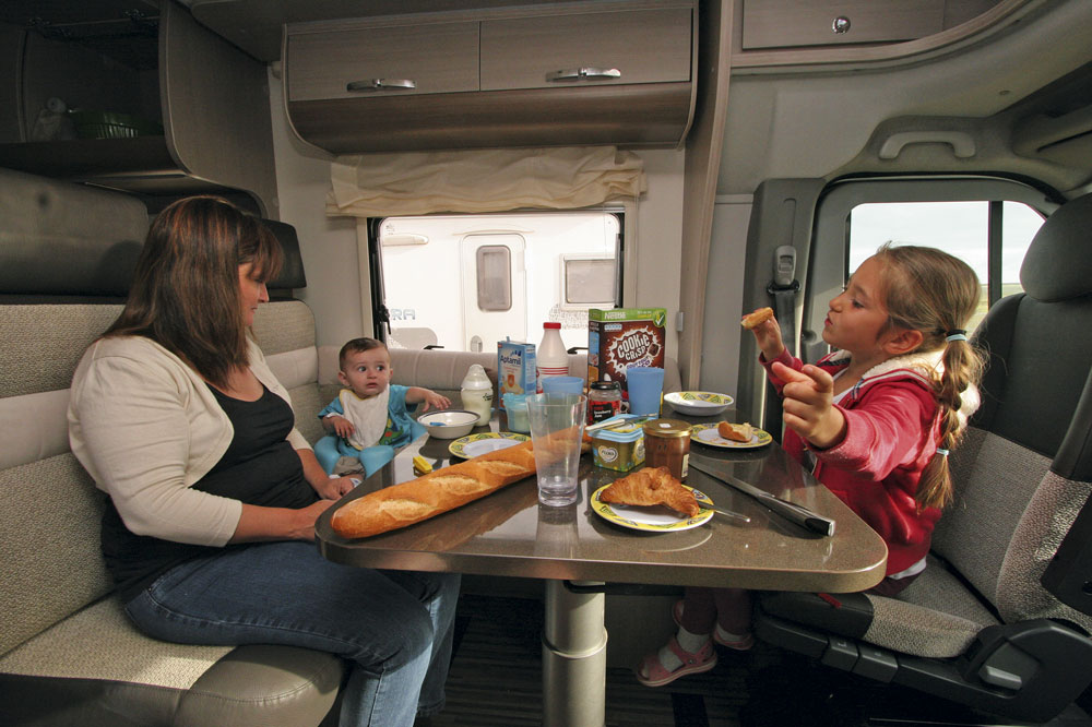 Family dining in a campervan