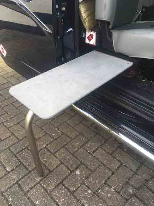 A campervan table positioned to the side of the vehicle