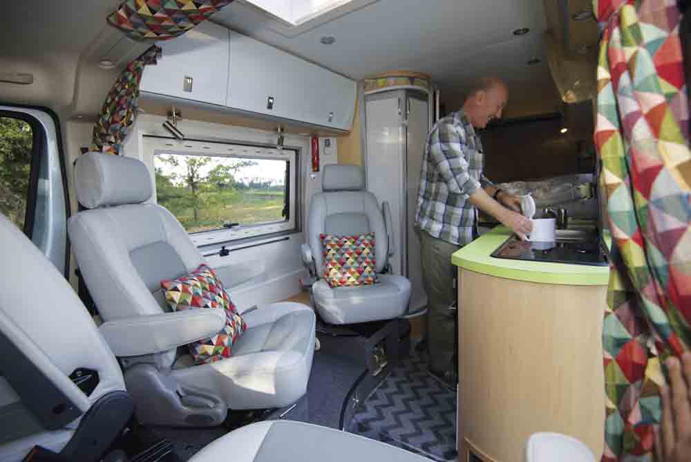Martin pictured in the kitchen of his self-built campervan