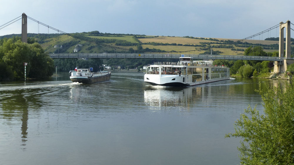 Image of a cruiser and barge on the River Seine in France