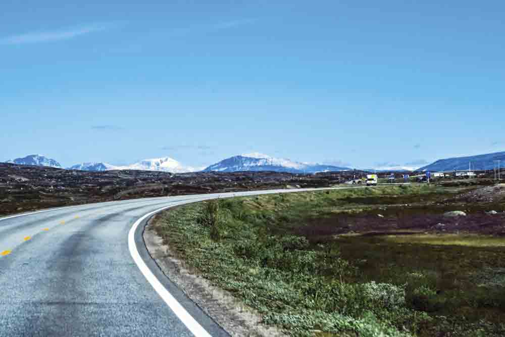 Image of a campervan driving in Norway, approaching the Arctic Circle