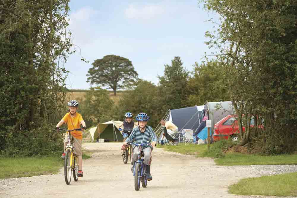 Image of children cycling on a campsite in Derbyshire