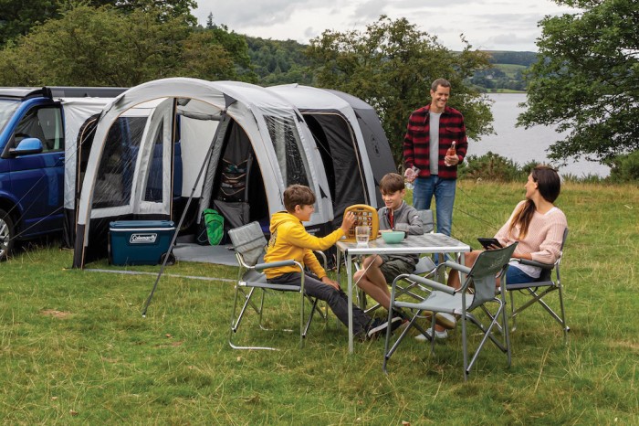 A family using a Coleman campervan awning