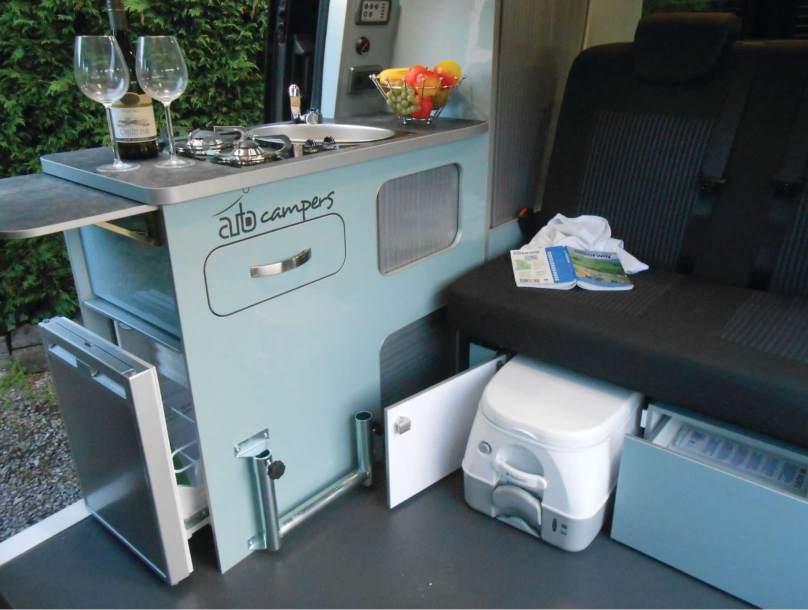 A portable toilet drawer inside of an Auto Campers leisure van