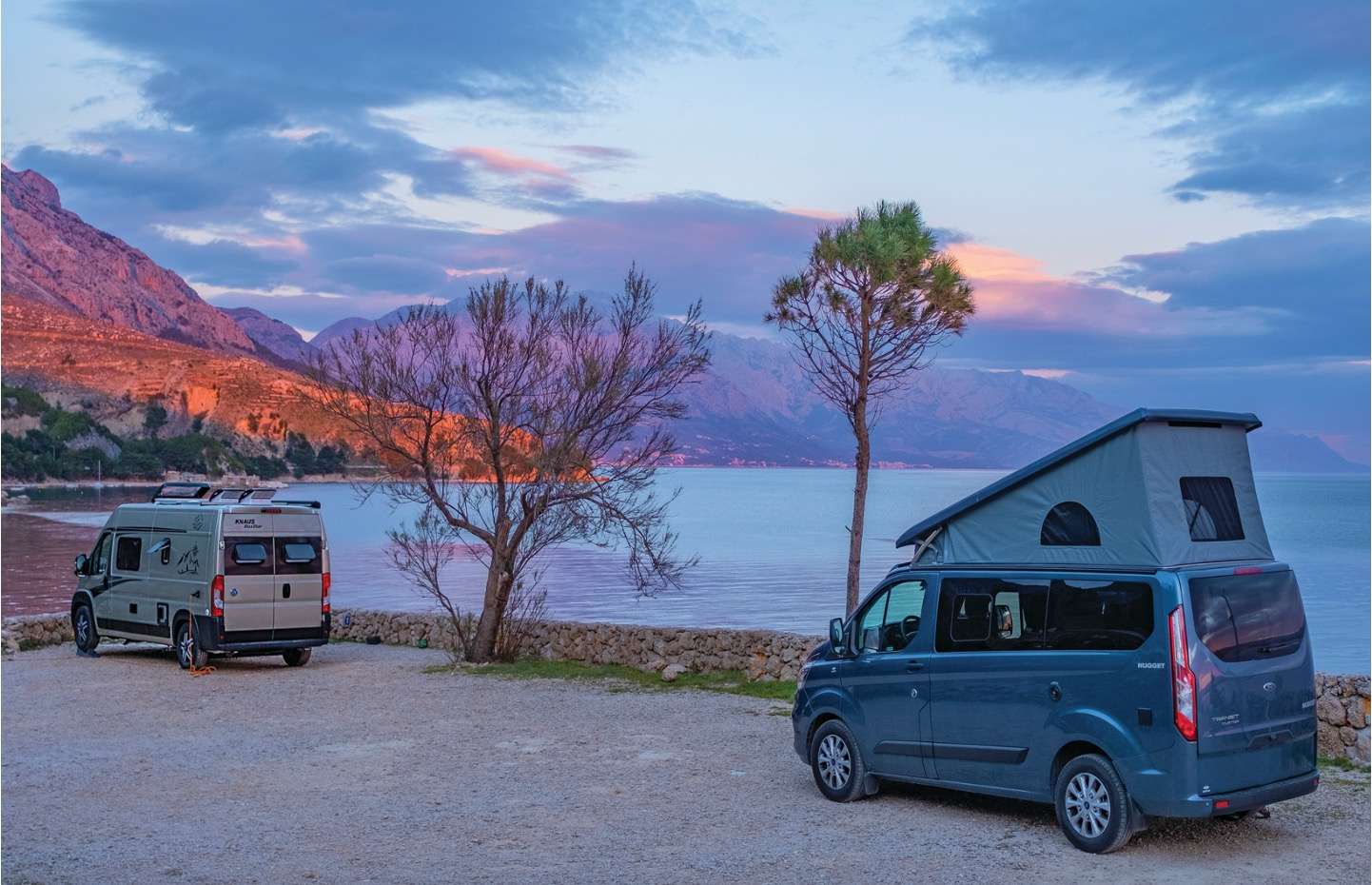 Campervans parked by a lake