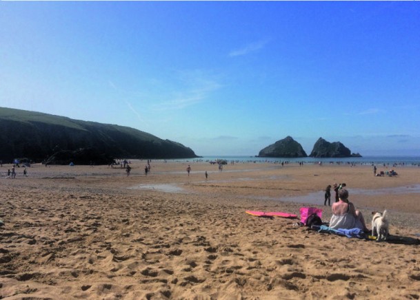 People relaxing at Holywell bay