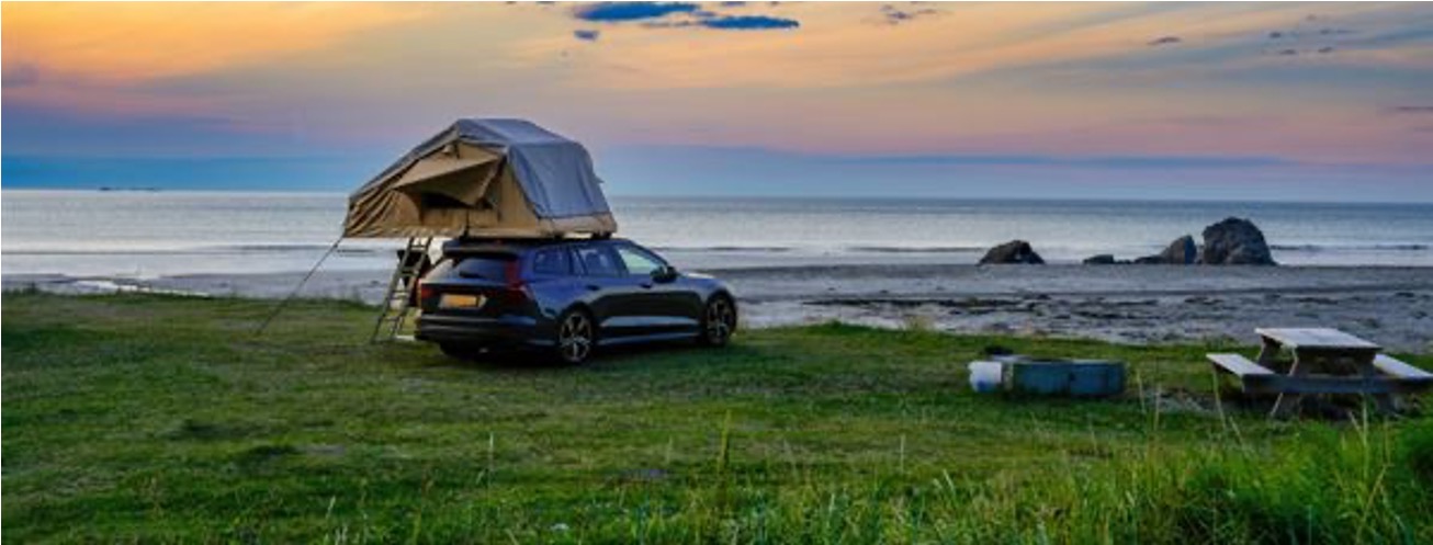 A roof tent with a coastal view (photo courtesy of stock.adobe.com)