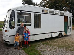 The family outside the bus