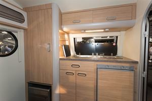 Three burners, a fridge, a wardobe and a heter across the front