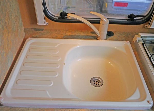 The original seized tap and chipped and worn enamel sink.