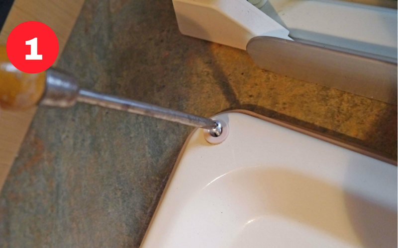Remove the cover plugs and long fixing screws.