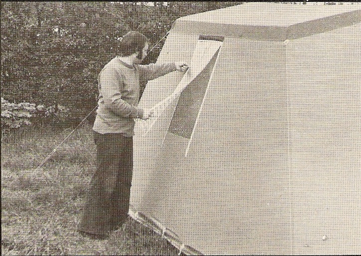 A man wearing flares while pitching a tent Black and whitie photo showing a man pitching a tent