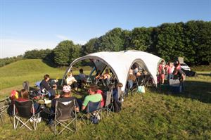 Gathering under an event shelter