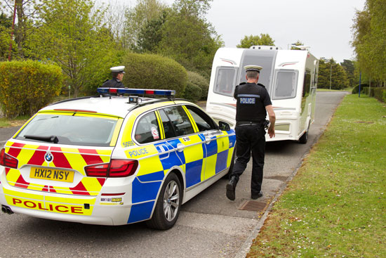 Police officers and caravan