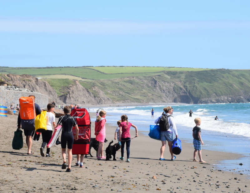 family on a beach in Cornwall with dog