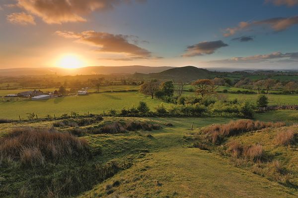 A view from Worston Moor looking down to Angram Green campsite at sunset