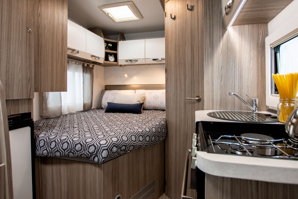The fixed double bed in the Benimar Primero 331 motorhome