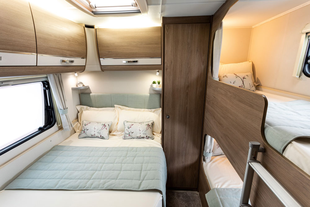 The double bed and bunks in the bedroom of the Compass Casita 868 caravan