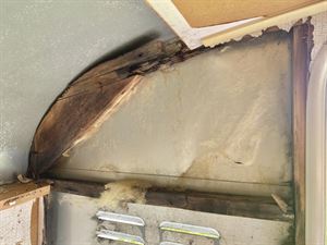 A large hole in the rotten frame of the caravan A large hole in the rotten frame of the caravan
