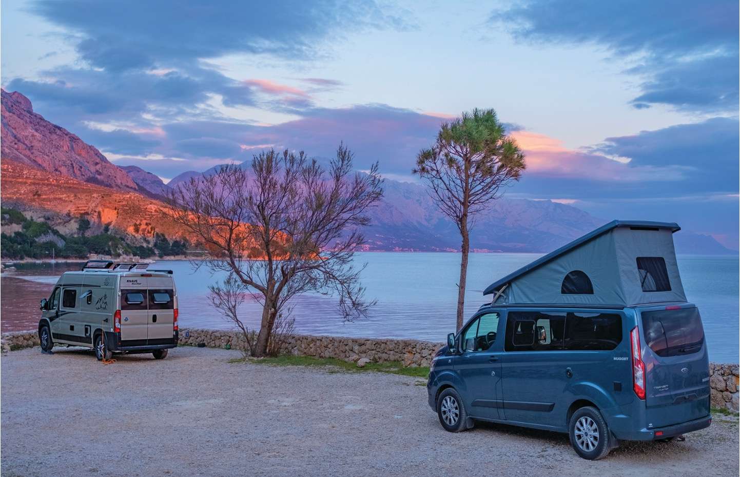 Campervans parked by a lake Campervans parked by a lake