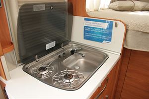 The compact kitchen still has room for a double gas hob