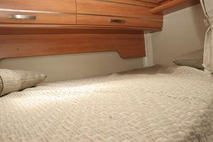 The bed is a transverse double, above the garage