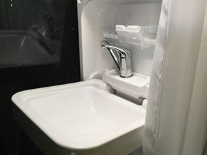 The washroom features a shower, loo and flip-down sink