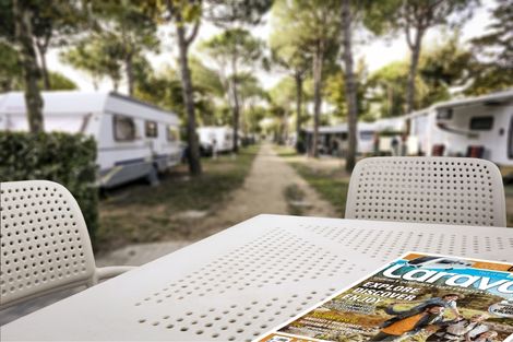 image of a caravan campsite with a caravan magazine laying on a table