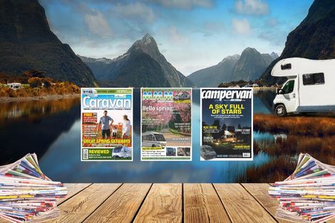 image of out and about lives magazines overlayed on a scenic image of a wooden bench, lake and motorhome.