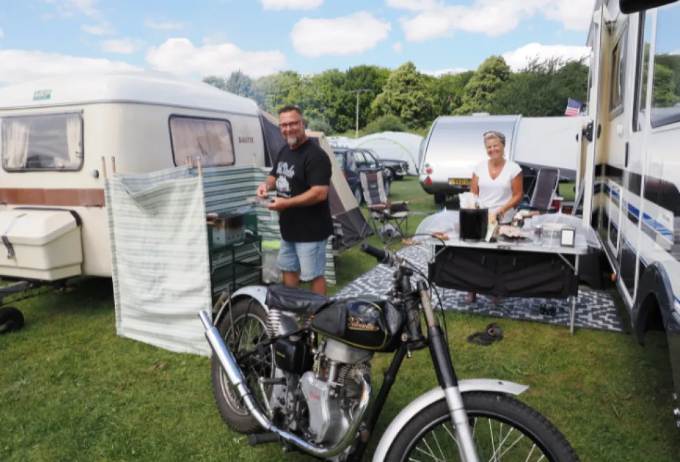 Couple having a bbq next to their motorhome
