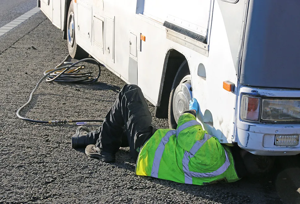 Motorhome spare wheel being fitted