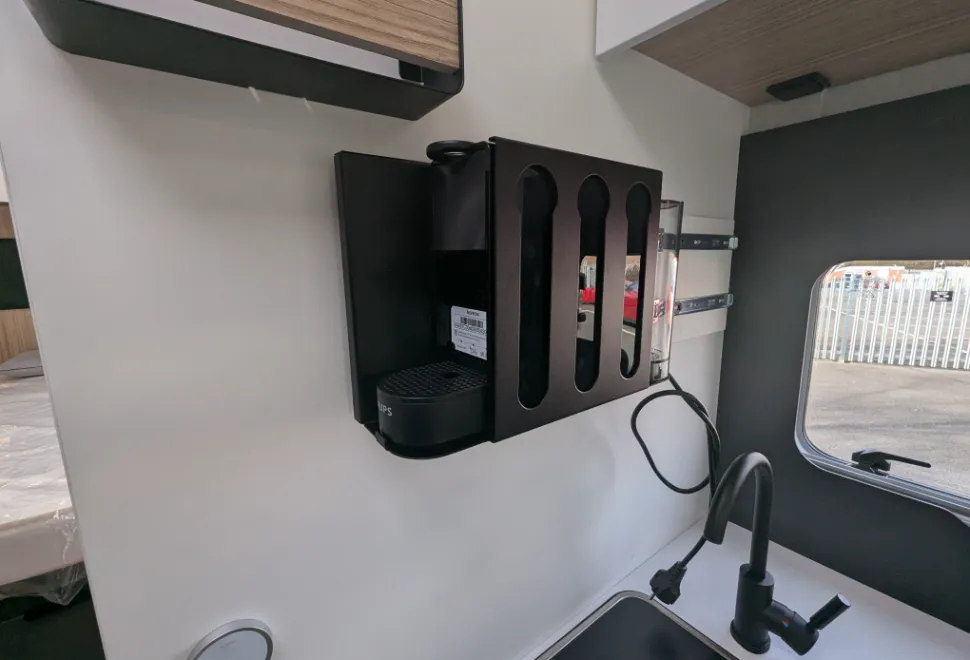 The coffee machine slides out on a sturdy bracket for access