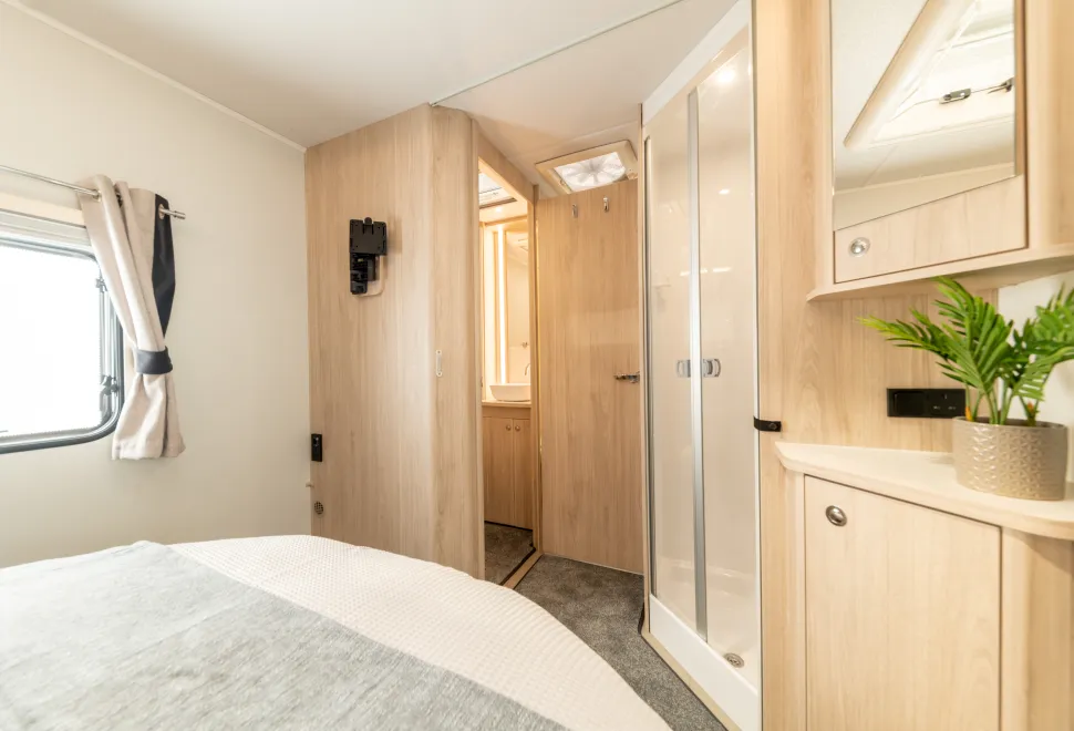 A cozy bedroom inside the Elddis Avante Apex 550