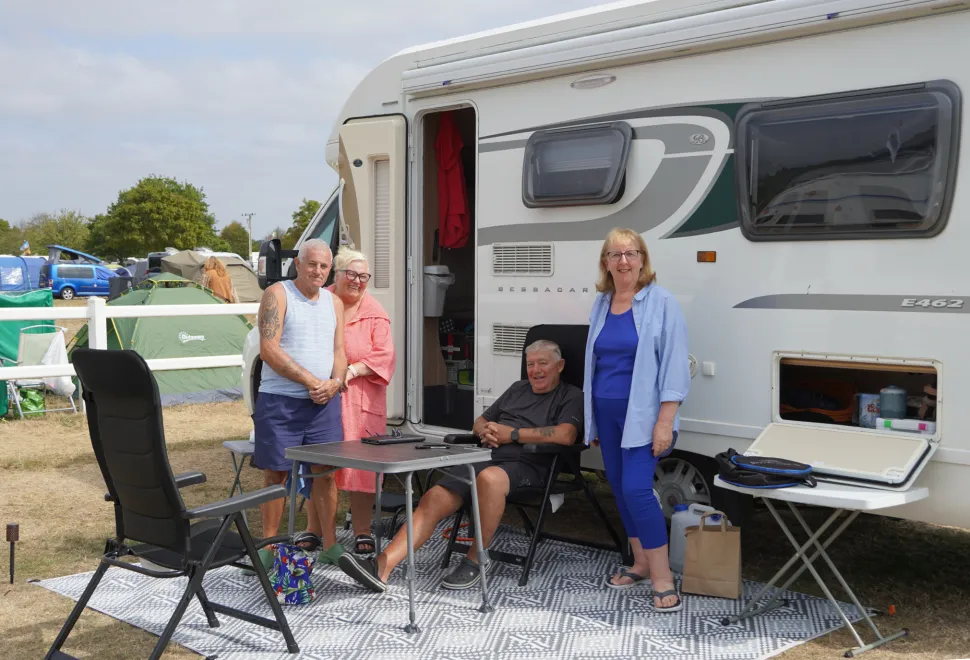 Friends meeting up under the Malvern foot hills on their camping pitches