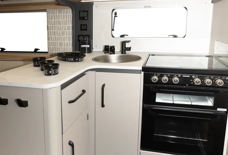 The L-shape gives the kitchen a slightly enclosed feel, almost like a separate room