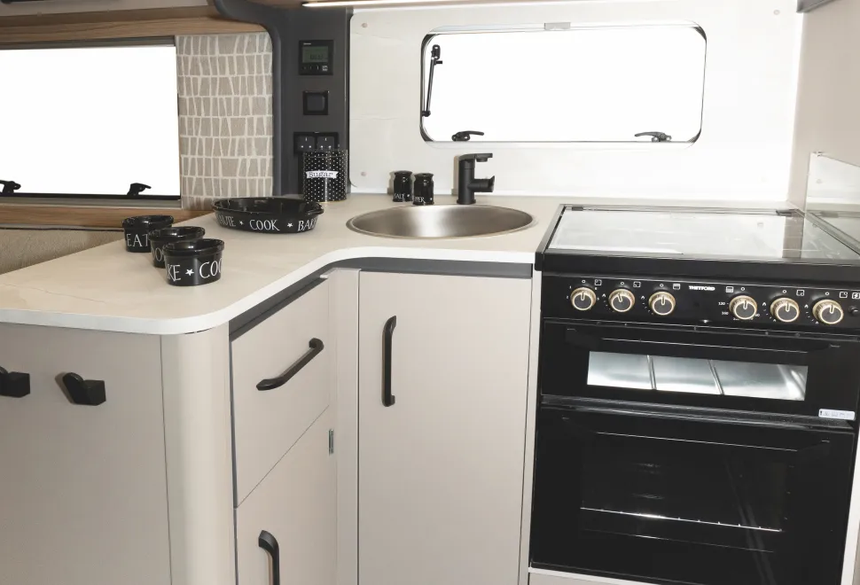 The L-shape gives the kitchen a slightly enclosed feel, almost like a separate room