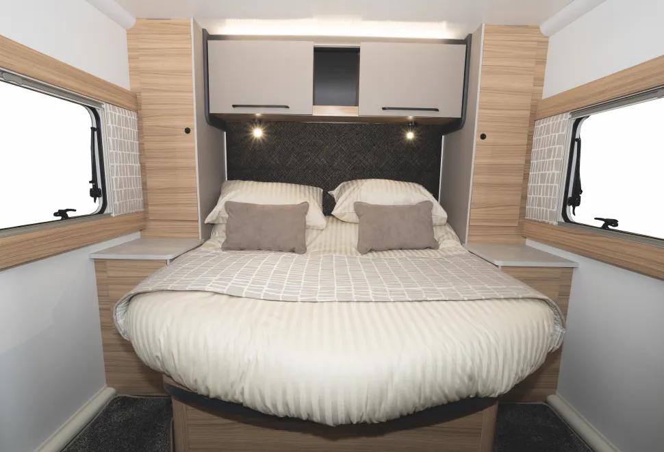 Large cabinets are on each side of the bed