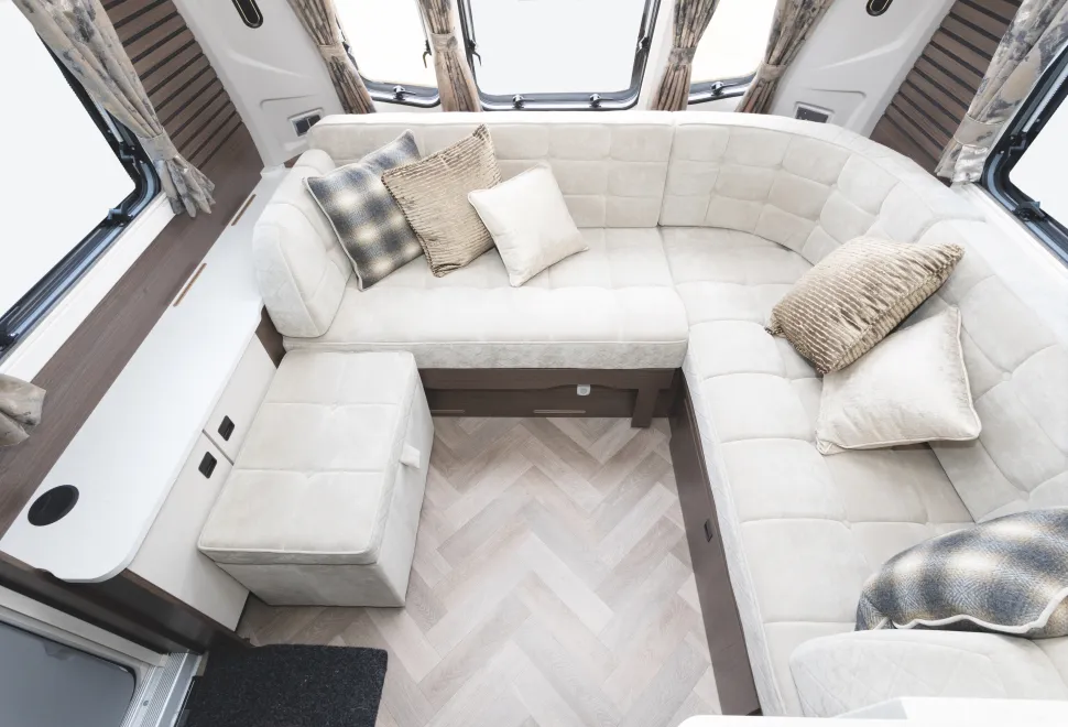 A sumptuous L-shaped lounge with a free- standing seat