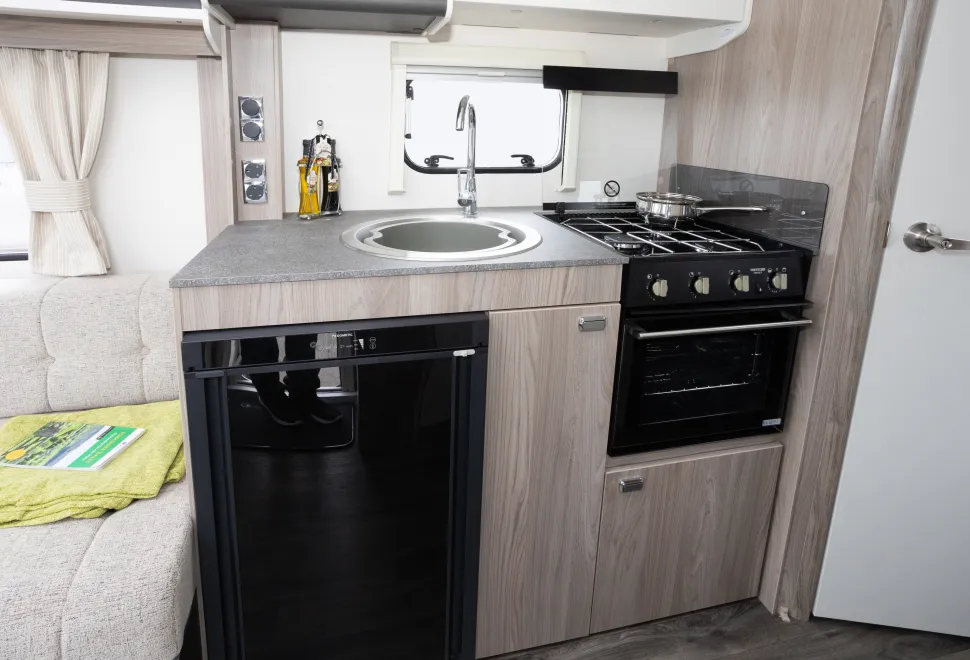 A large sink and a three-burner hob
