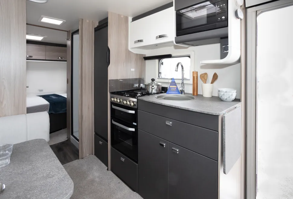 An open kitchen leading towards the rear bedroom