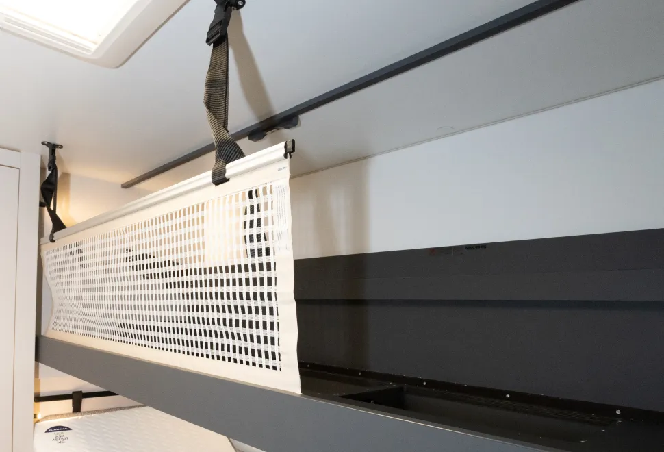 A mesh panel to prevent the bunk occupant from falling out.