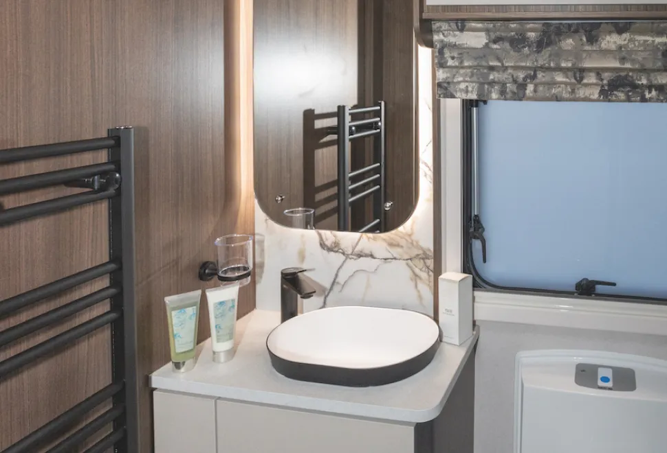 Black fittings and a backlit mirror