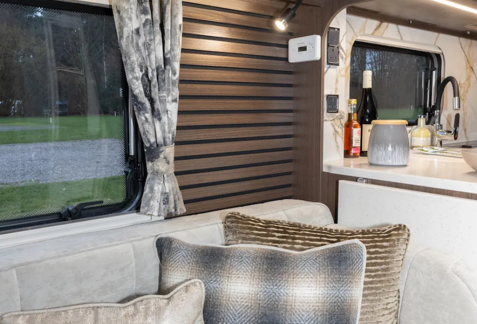 Three cushion fabrics, one with a golden lustre, one with a cosy wool weave and one with ridges of tactile material
