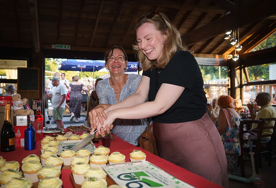 Clare Mackenney and Grace Lawrence cutting the cake