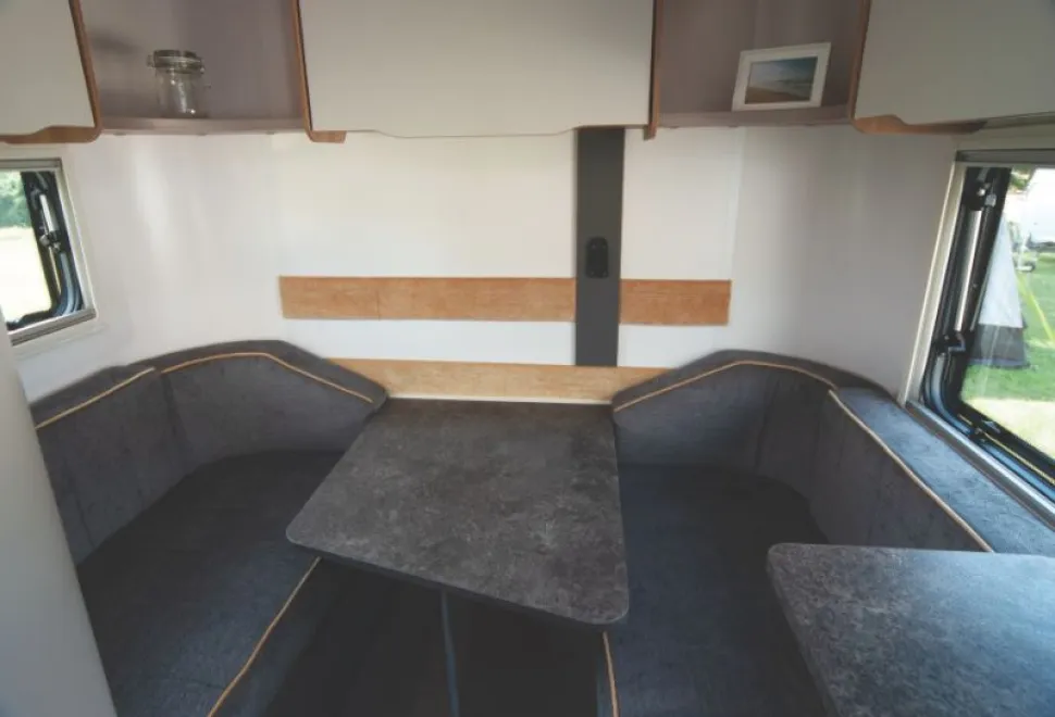 A-wedge-shaped-table-at-the-rear,-plus-white-fronted-overhead-lockers-and-shelves-18445