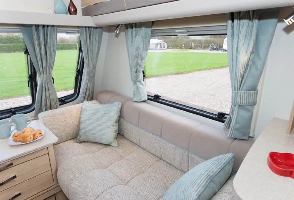 web-The-unique-Osprey-fabric-scheme-features-cushions-and-curtains-with-a-subtle,-light-reflecting-pattern-12759