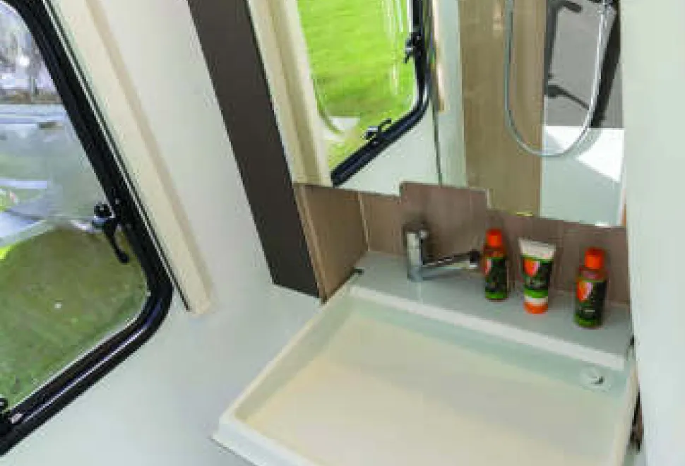 A-large,-shallow-basin-hinges-down-from-within-the-mirrored-cabinet-w350-67247